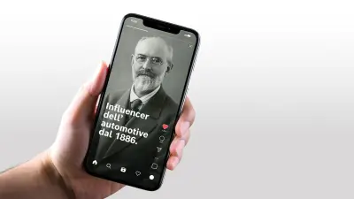 Primo di piano di una mano che regge uno smartphone su cui è visualizzato il post di un social media con un ritratto d'epoca di Robert Bosch, accompagnato dal testo "Influencer dell’automotive dal 1886".